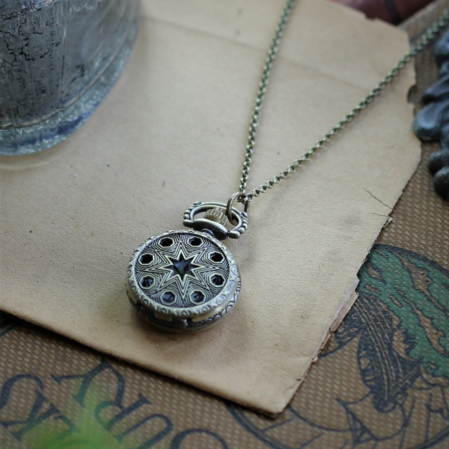 Stars and Pinwheels Battery Operated Pocket Watch Necklace in Antiqued Brass