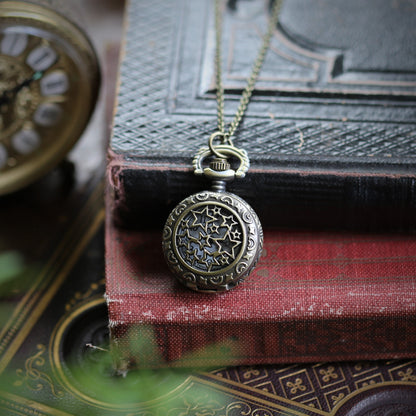 Stars and Pinwheels Battery Operated Pocket Watch Necklace in Antiqued Brass