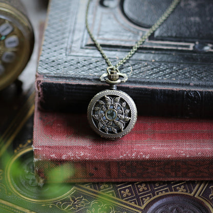 antiqued brass wearable pocket watch necklace with three butterflies. Battery operated.