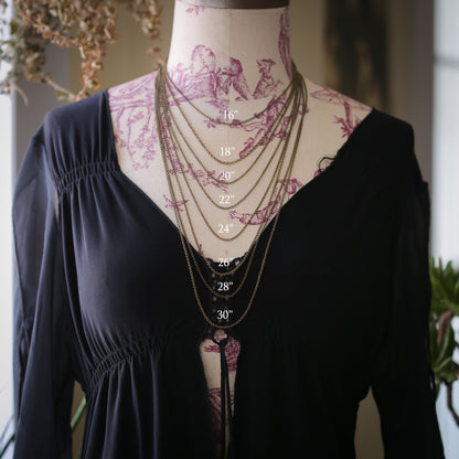 A bust displaying chain length options: 16", 18", 20", 22", 24", 26", 28", and 30".
