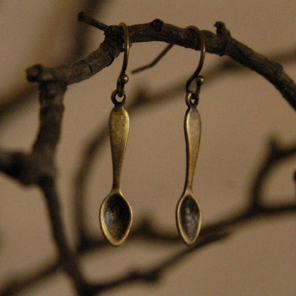 A pair of brass teaspoon dangle earrings.