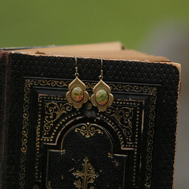 Antiqued brass earrings with unakite cabochons on deco drop settings.