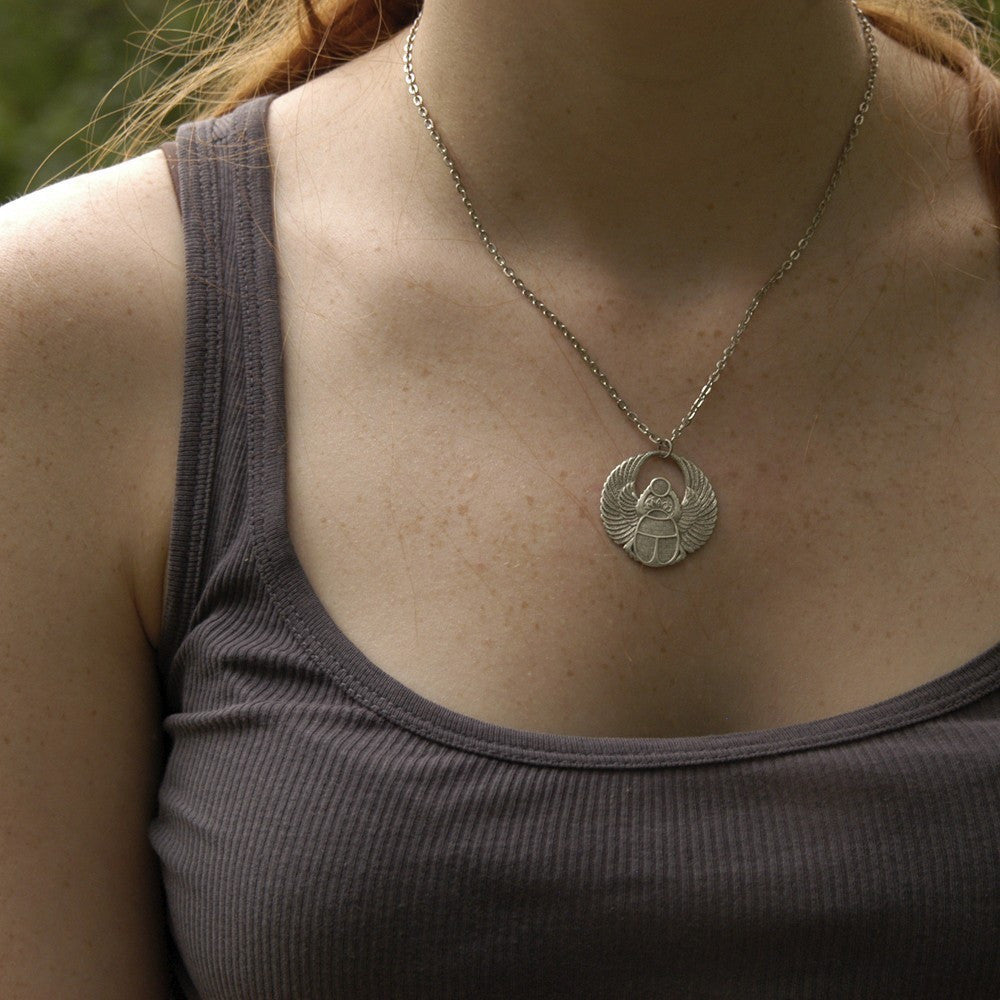 Antiqued silver scarab beetle pendant on a simple chain. Pendant is in a circular Art Deco design.