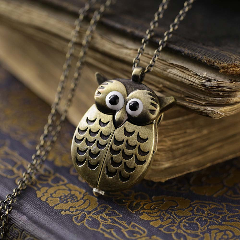 A bronze owl-shaped watch necklace. This watch is closed with the owl's wings covering the watch face.