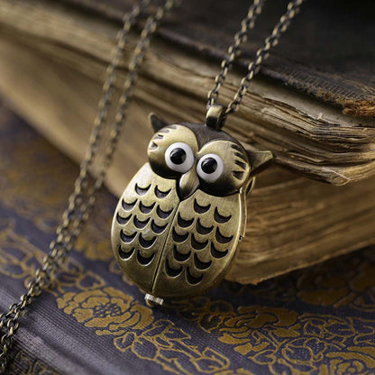 A bronze owl-shaped watch necklace. This watch is closed with the owl's wings covering the watch face.