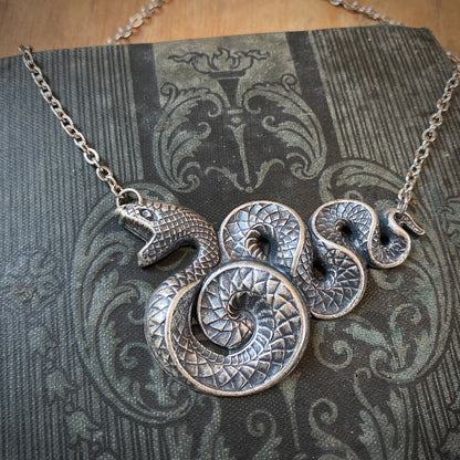 Antiqued brass Victorian snake pendant necklace.