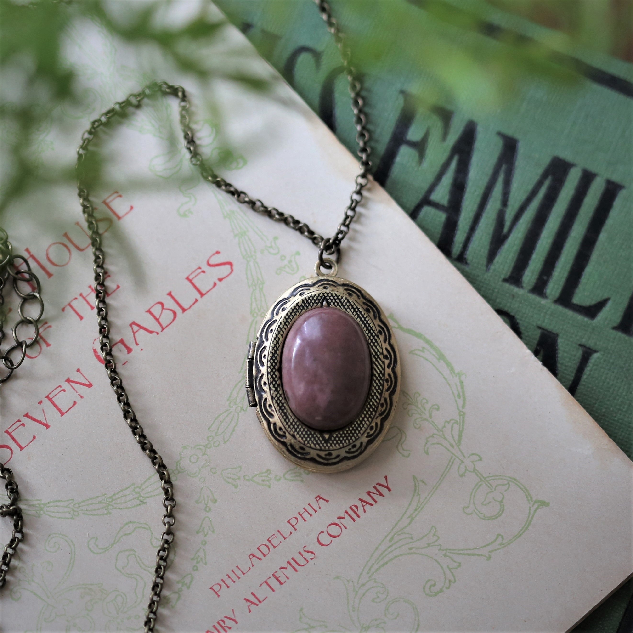 antiqued brass pastel academia oval locket necklace with rose pink rhodonite semi precious stone mineral cabochon