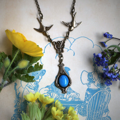 Antiqued brass vintage-style blue howlite drop pendant featuring birds in a winter classic lolita style.