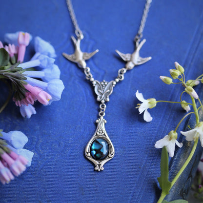 Antiqued silver vintage-style blue shell drop pendant featuring birds in a winter wedding style.