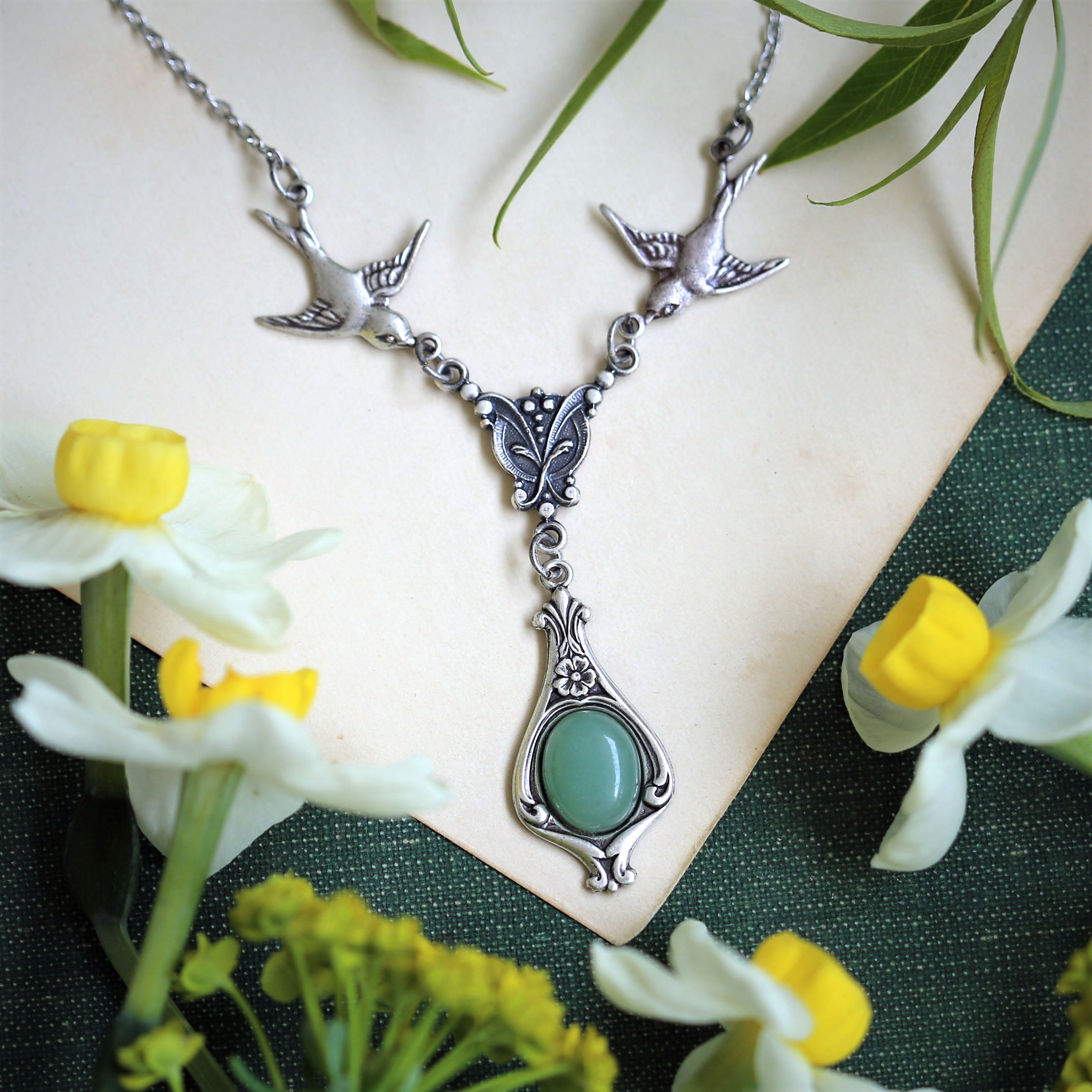 Antiqued silver vintage-style green aventurine drop pendant featuring birds in a light woodland princess style.