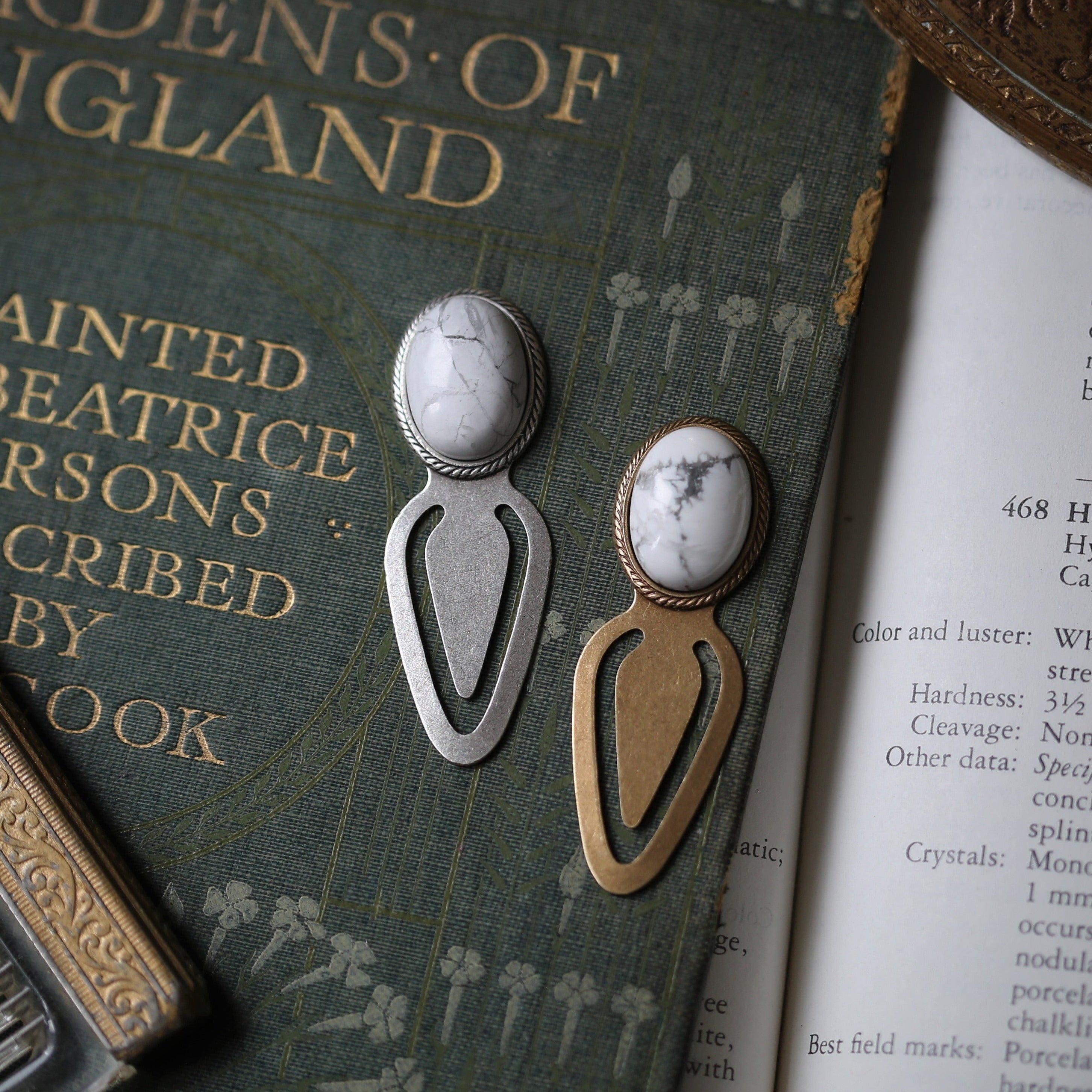 Antiqued brass and silver metal clip bookmarks with oval semi-precious oval stone cabochons in white howlite for winter academia style gift for writer