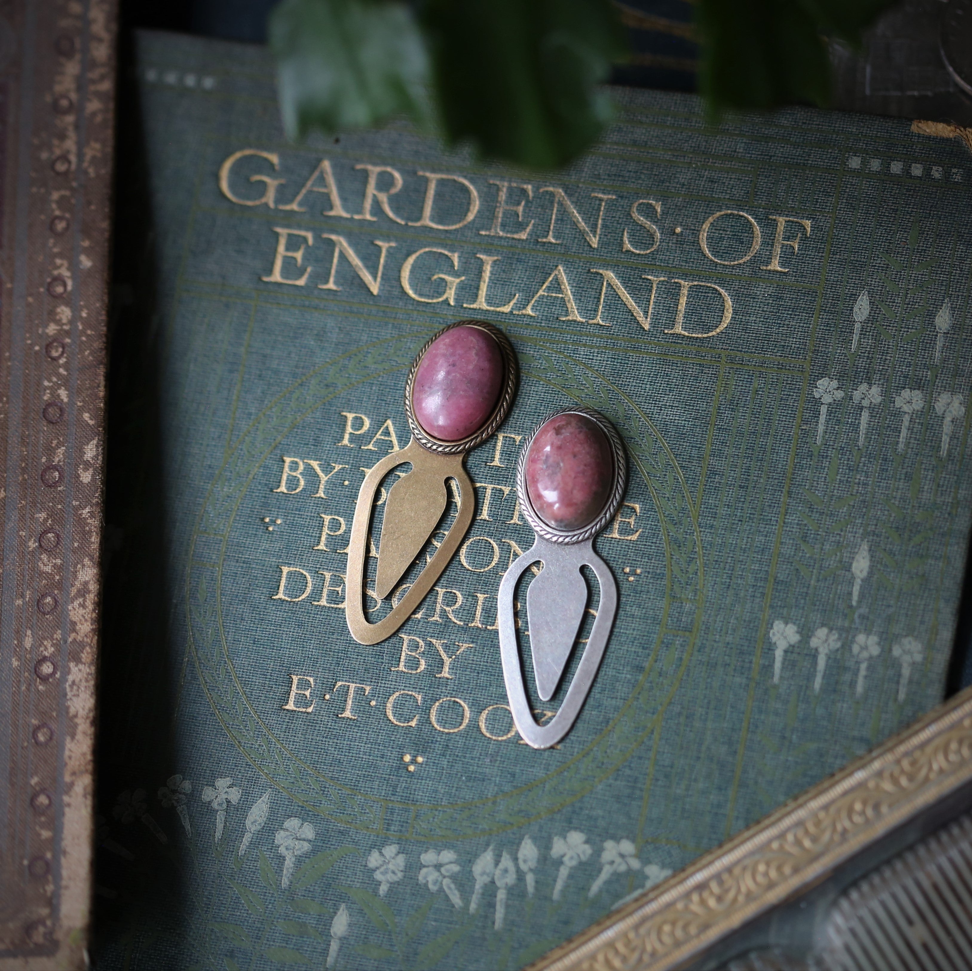 antiqued silver or brass pink rhodonite stone mineral oval cabochon set on a clib bookmark a great gift for bookworms, readers, writers, or teachers in academia aesthetic