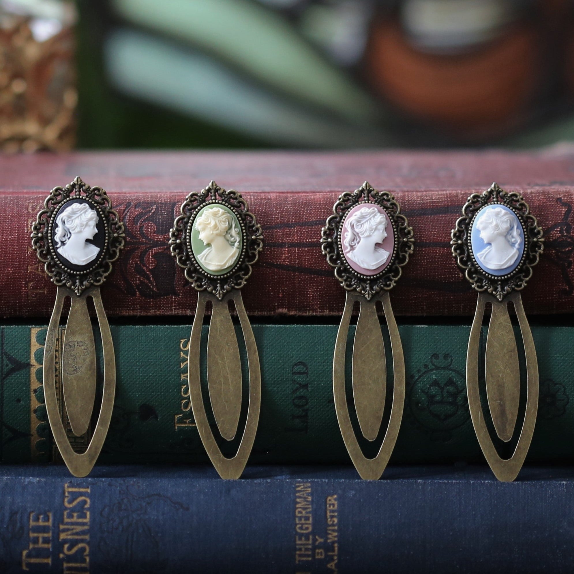 antiqued brass modern vintage inspired oval cameo clip bookmark with black green pink or blue background and white lady profile cameo a perfect gift for tutors, writers, editors, librarians, and other bibliophiles.