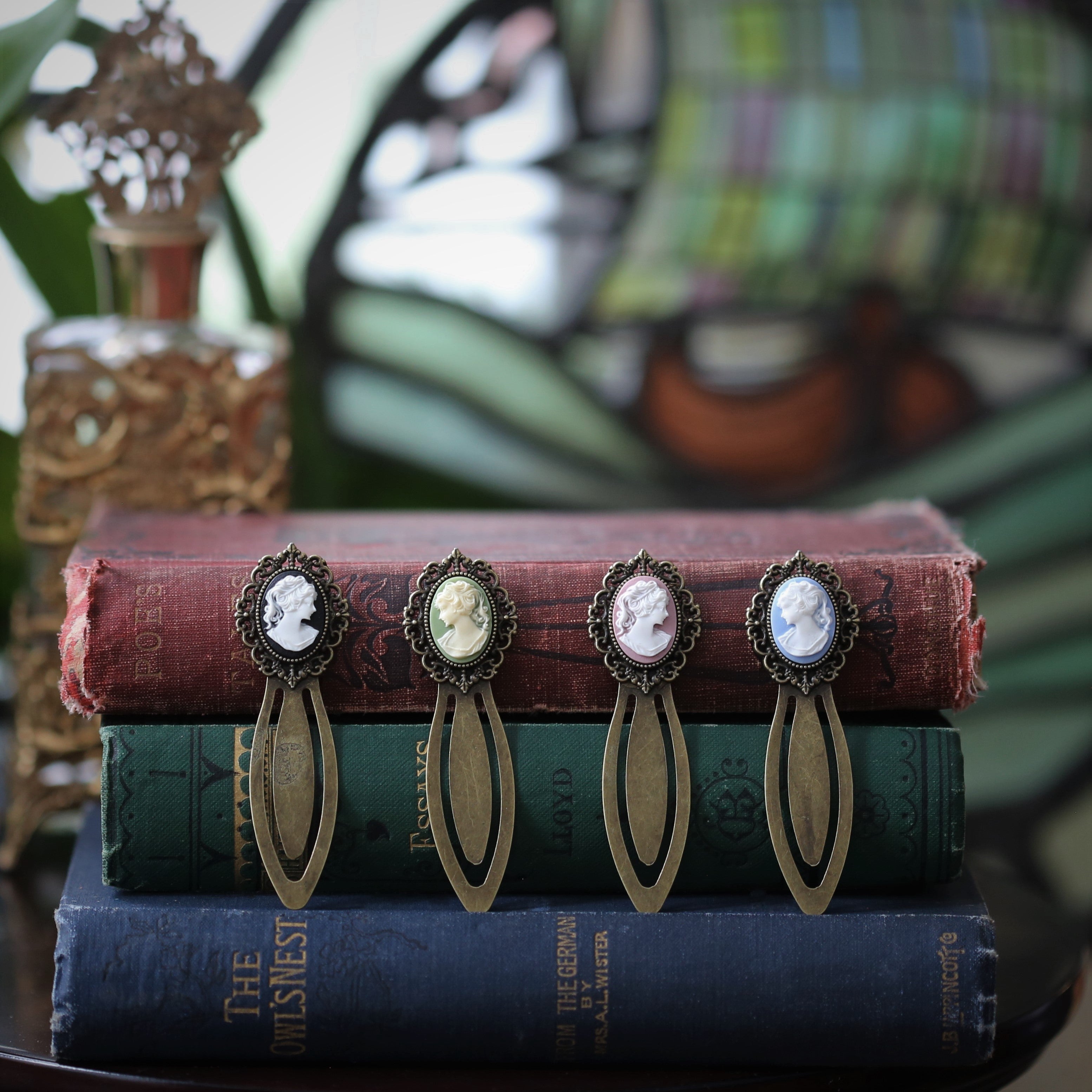 antiqued brass modern vintage inspired oval cameo clip bookmark with black green pink or blue background and white lady profile cameo a perfect gift for tutors, writers, editors, librarians, and other bibliophiles.