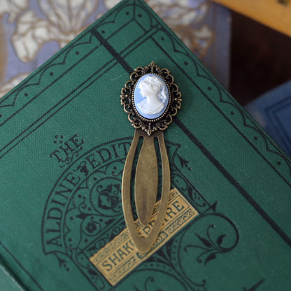 antiqued brass modern vintage inspired oval cameo clip bookmark with blue background and white lady profile cameo a perfect gift accessory with a book.