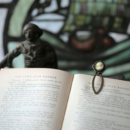 antiqued brass modern vintage inspired oval cameo clip bookmark with black background and white lady profile cameo a perfect gift for teachers.