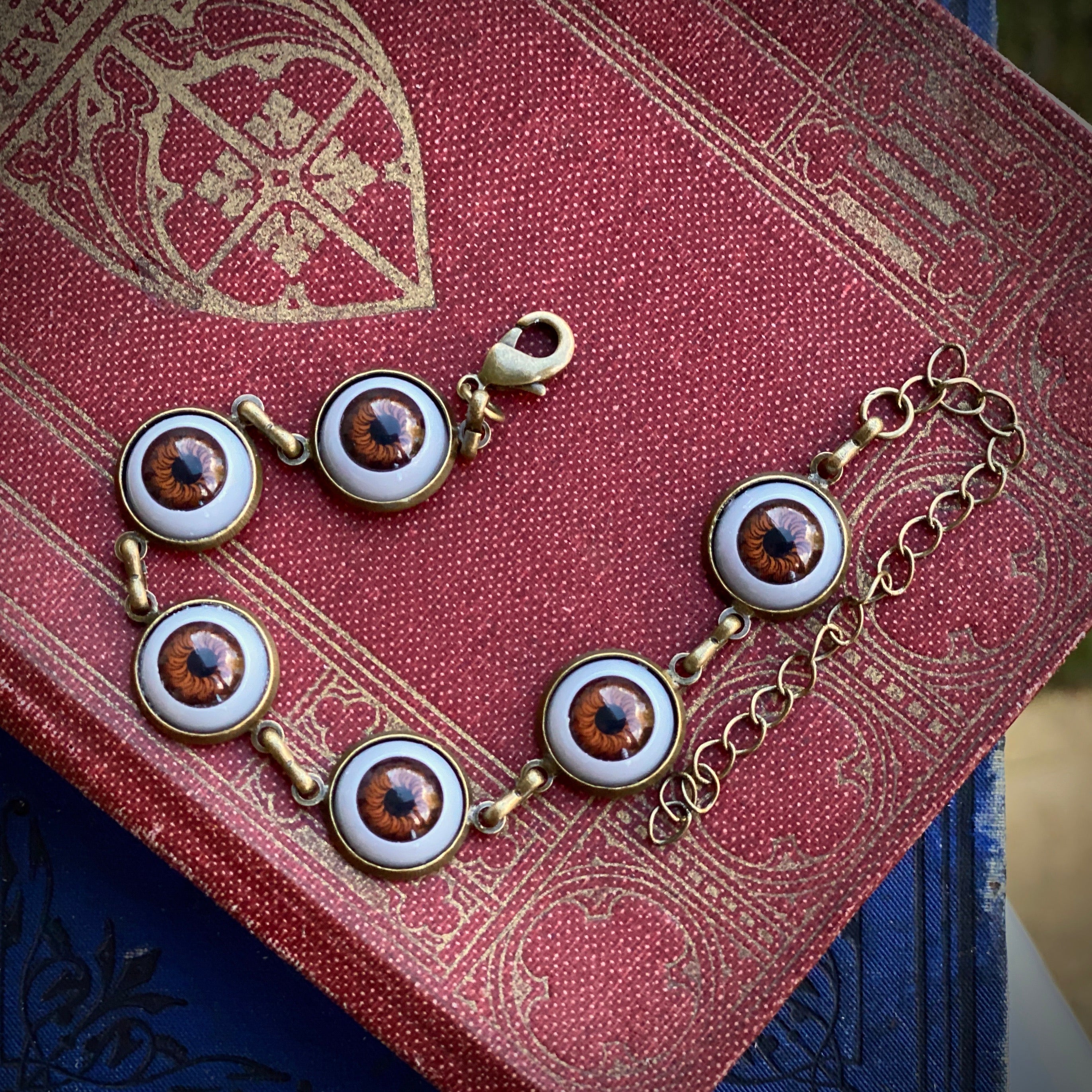 antiqued brass ghostcore style adjustable brown dolls evil eye charm dangle bracelet.