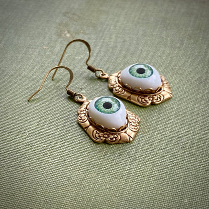 antiqued brass vintage-style oval green dolls evil eye drop dangle earring charms all seeing eye side shot to show height