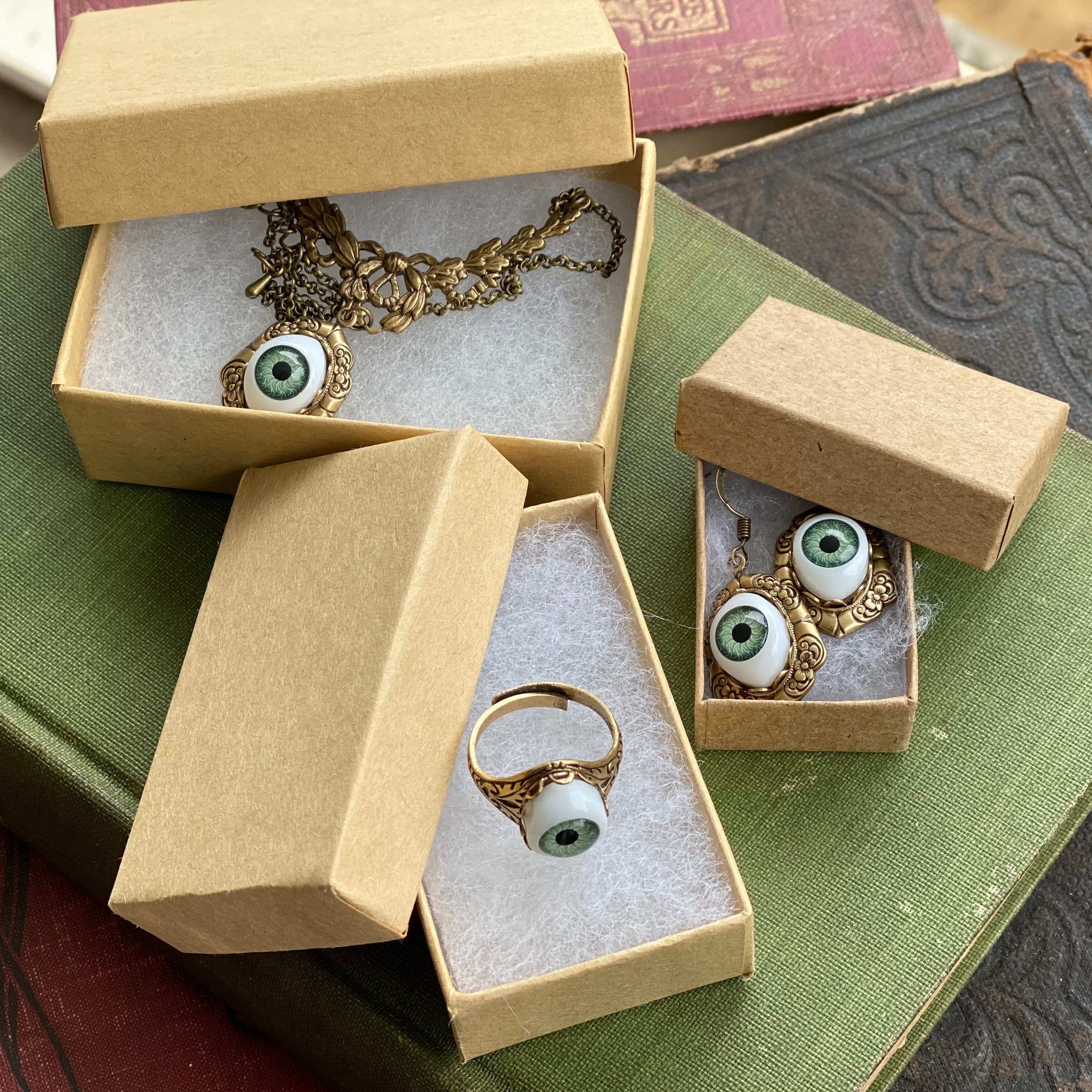 antiqued brass vintage-style oval green dolls evil eye earrings ring and necklace in gift boxes ready to share