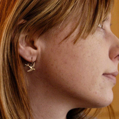 Brass earrings with flying bird charms