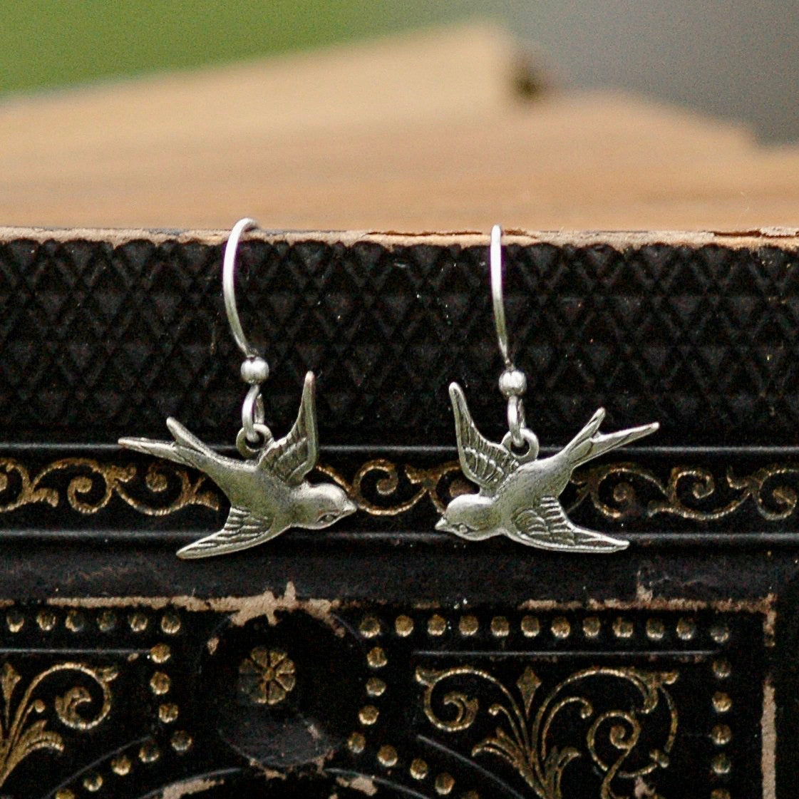 Silver earrings with flying bird charms