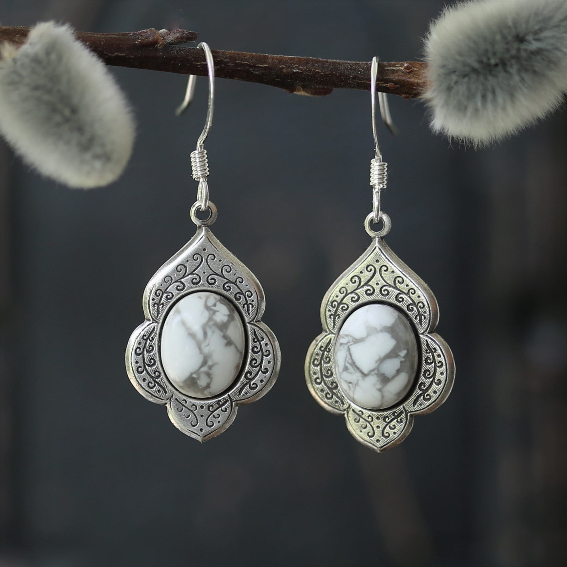 antiqued silver vintage style leaf shaped dangle drop earrings with a white and gray howlite stone oval cabochon.