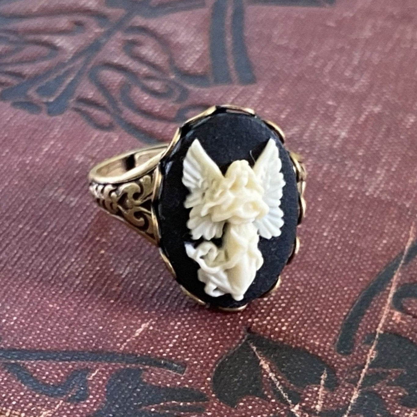 Antiqued brass retro vintage style adjustable ring with black and white angel cameo ring.