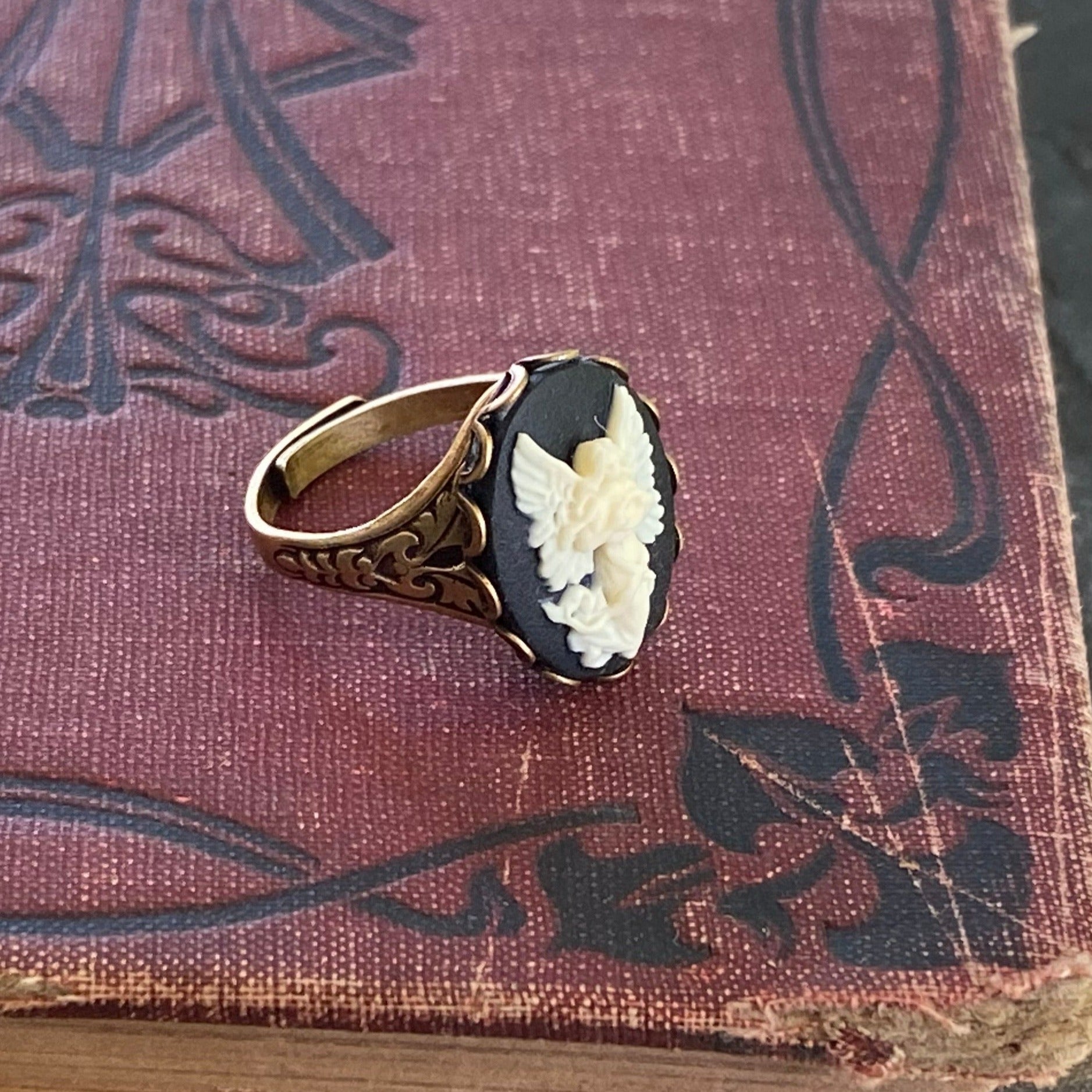 Antiqued brass retro vintage style adjustable ring with black and white angel cameo ring.