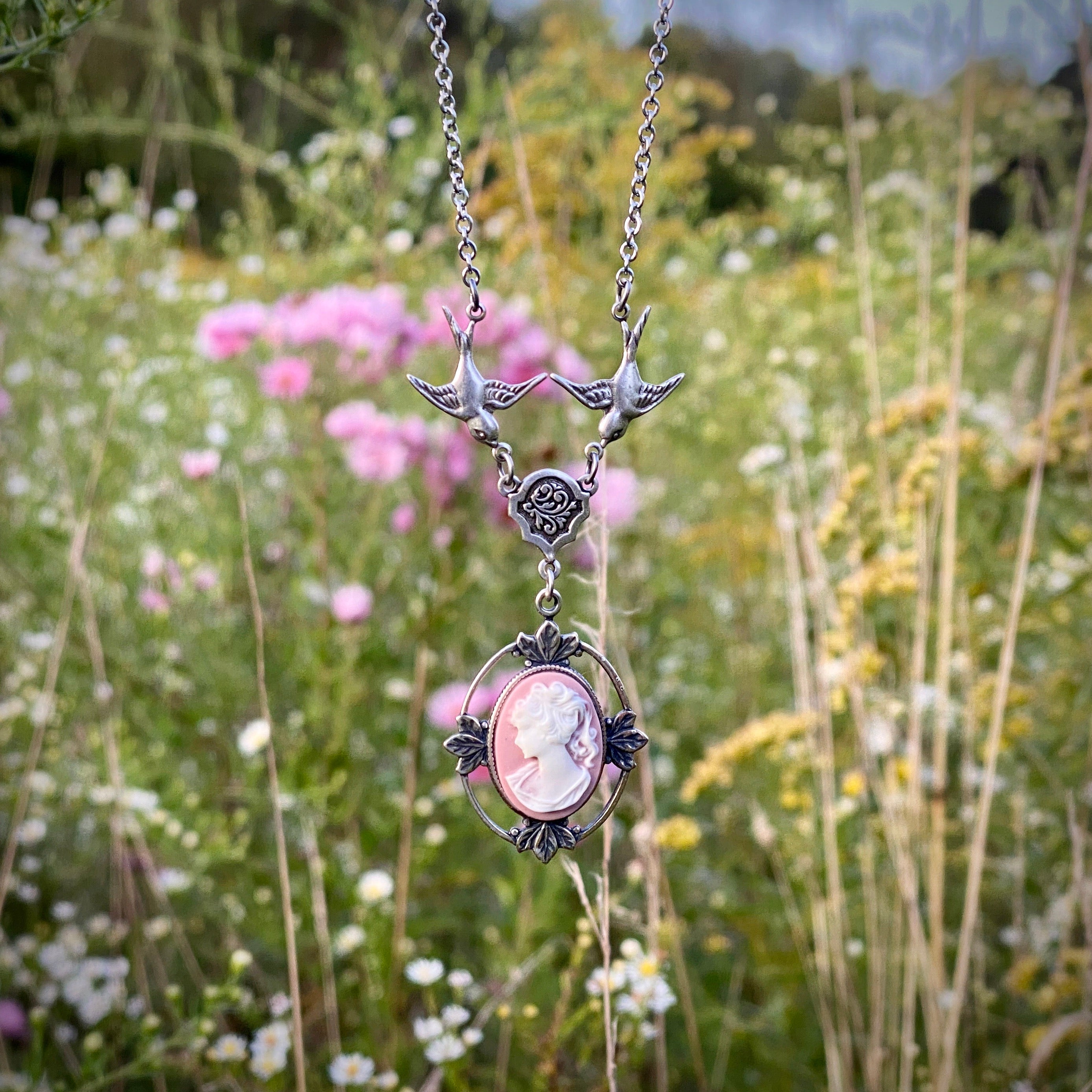 Antiqued silver Victorian lady white on pink cameo necklace on a chain with birds.