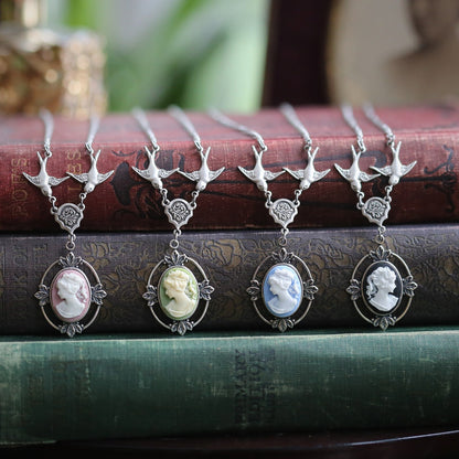 Antiqued silver Victorian lady cameo necklaces on chains with birds. Pink, green, blue, and black cameo options.