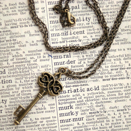 Antiqued brass infinity and hearts key pendant.