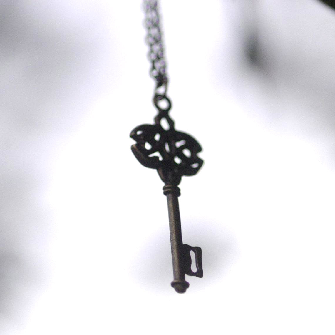 Antiqued brass infinity and hearts key pendant.