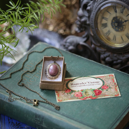 antiqued brass modern vintage style oval locket with a pink rhodonite or rose quartz the perfect gift to remember