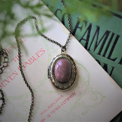 antiqued brass modern vintage style oval locket with a pink rhodonite or rose quartz in the danish pastel style