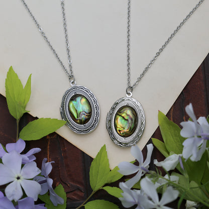 antiqued silver vintage style oval locket with a yellow green sea shell cabochon in bookstore girl aesthetic a perfect nostalgic  gift for a book lover.