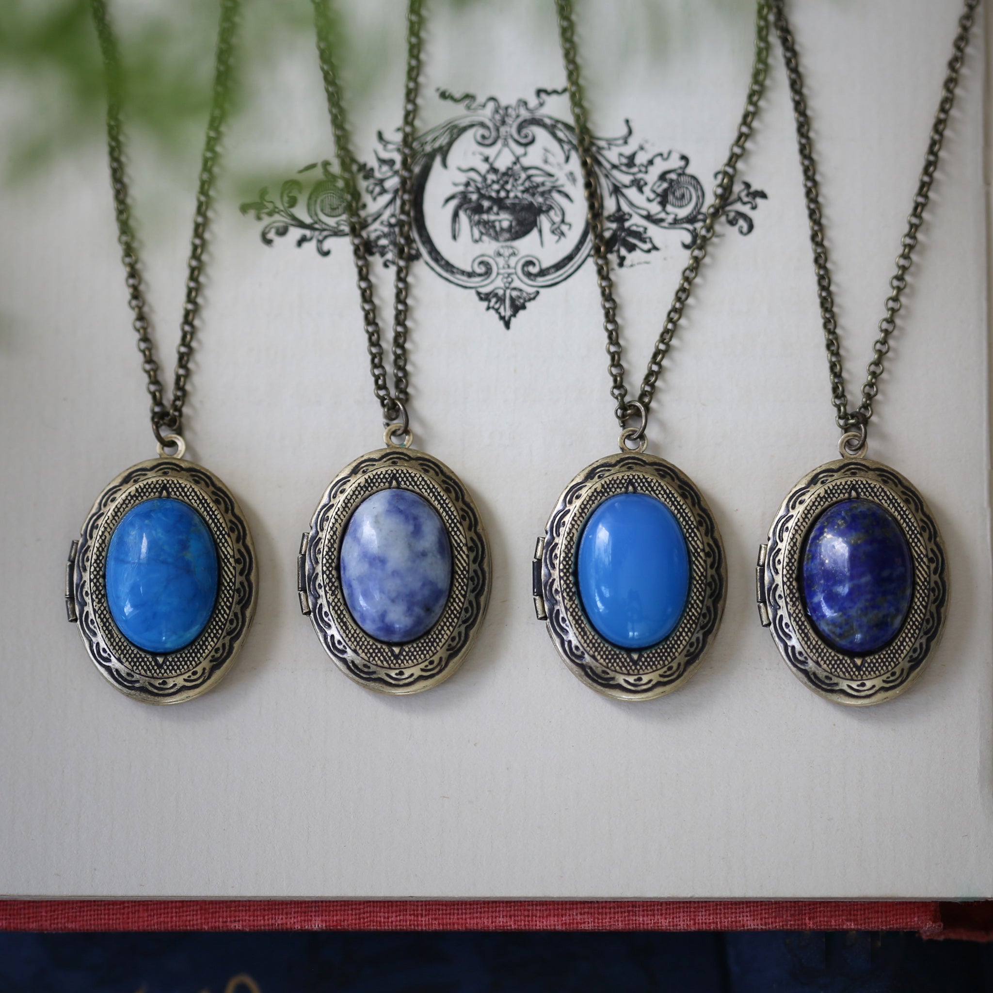 antiqued brass vintage style blue semi-precious mineral oval stone lockets in coastal cowgirl style