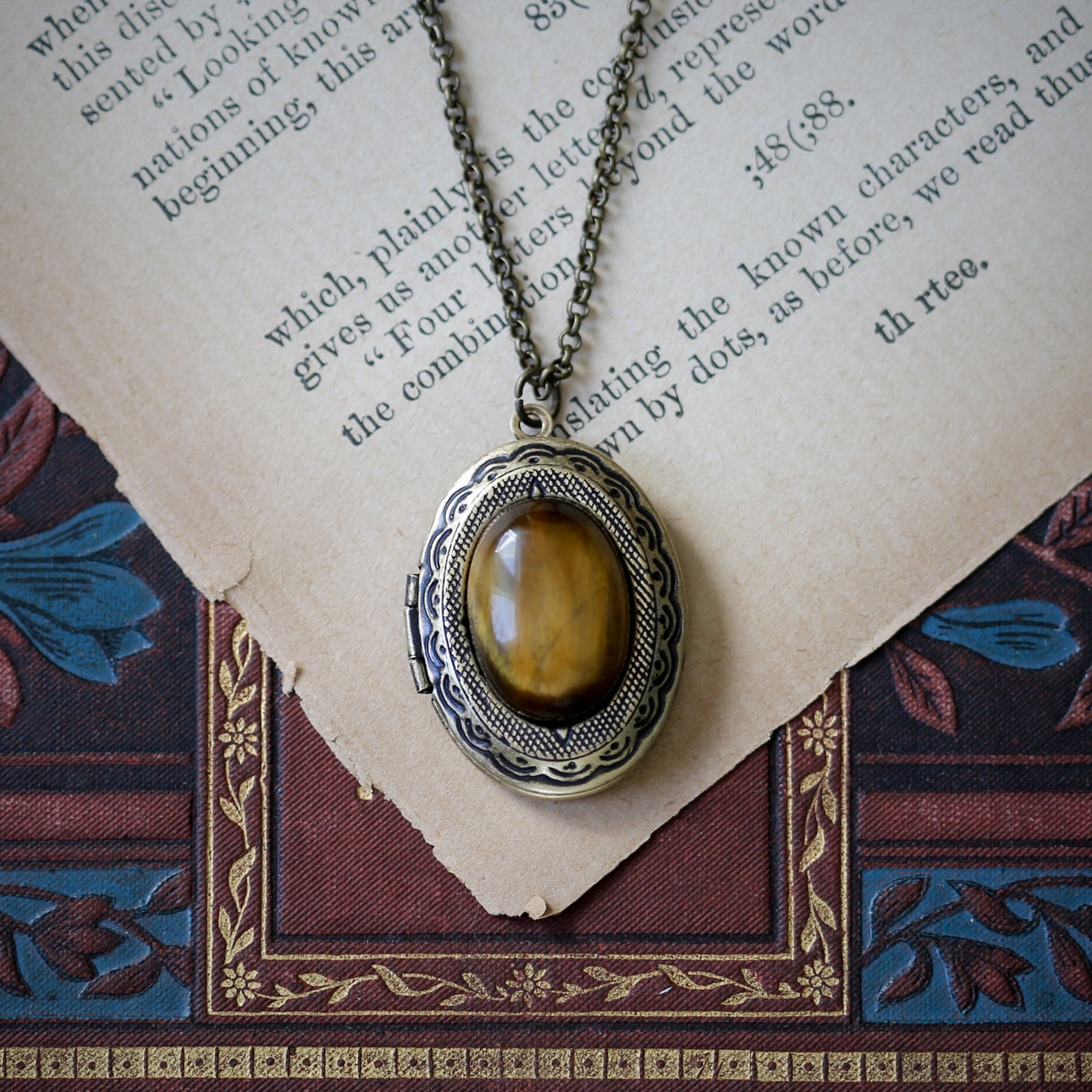 Antiqued brass vintage style long oval brown tiger eye semi-precious stone mineral locket in casual fall aventurecore style great sentimental gift for loved one.