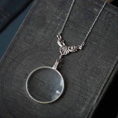 antiqued silver vintage style monocle magnifying glass useful necklaces with various Victorian leaf flourish filigree.