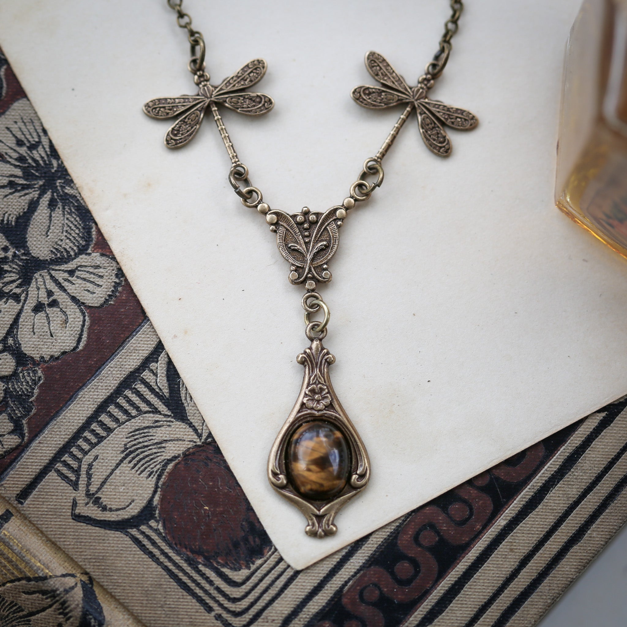 antiqued brass vintage-style dragonfly and brown tiger eye stone pendant drop necklace in autumn academia style