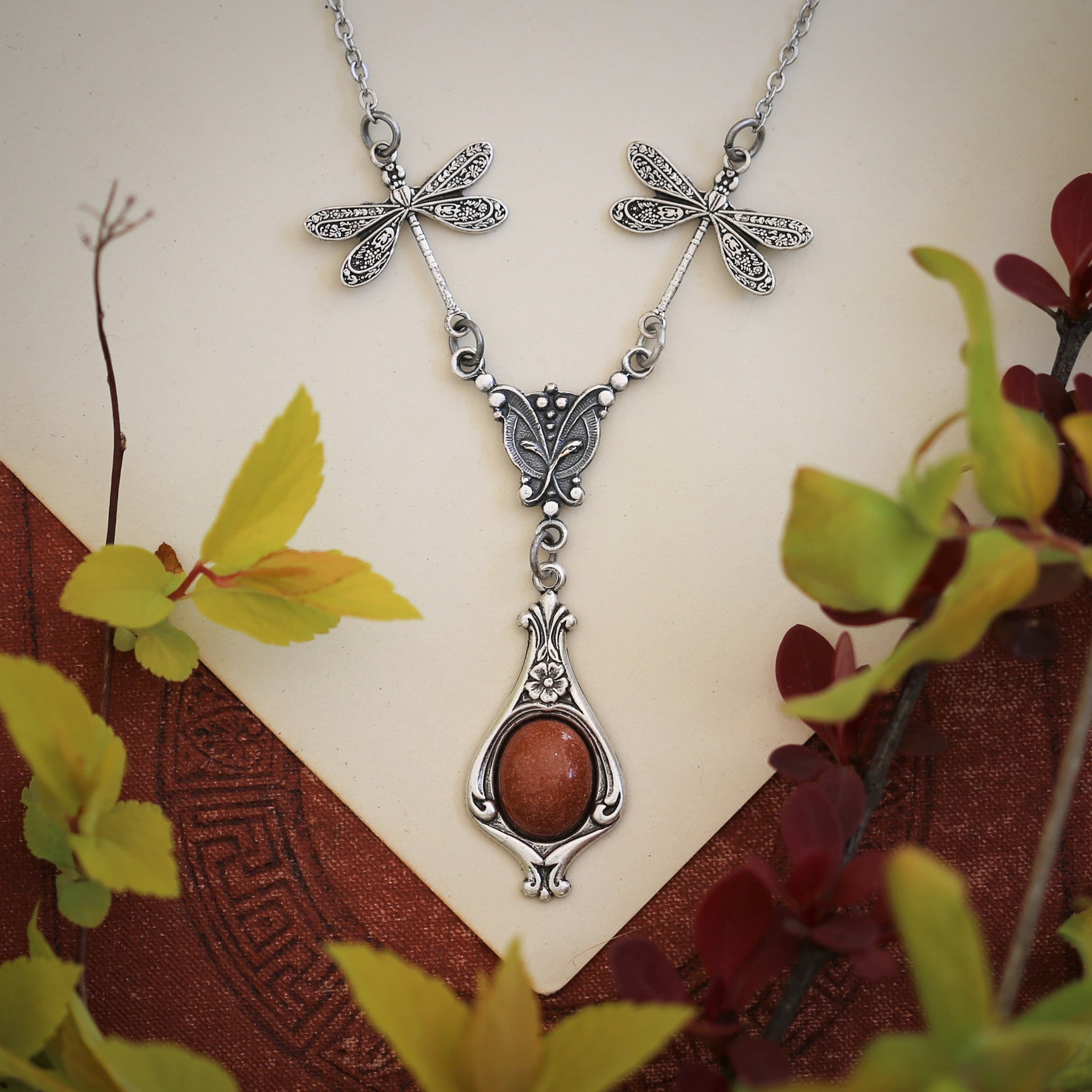 antiqued silver vintage-style dragonfly and orange sunstone pendant drop necklace in autumn academia style