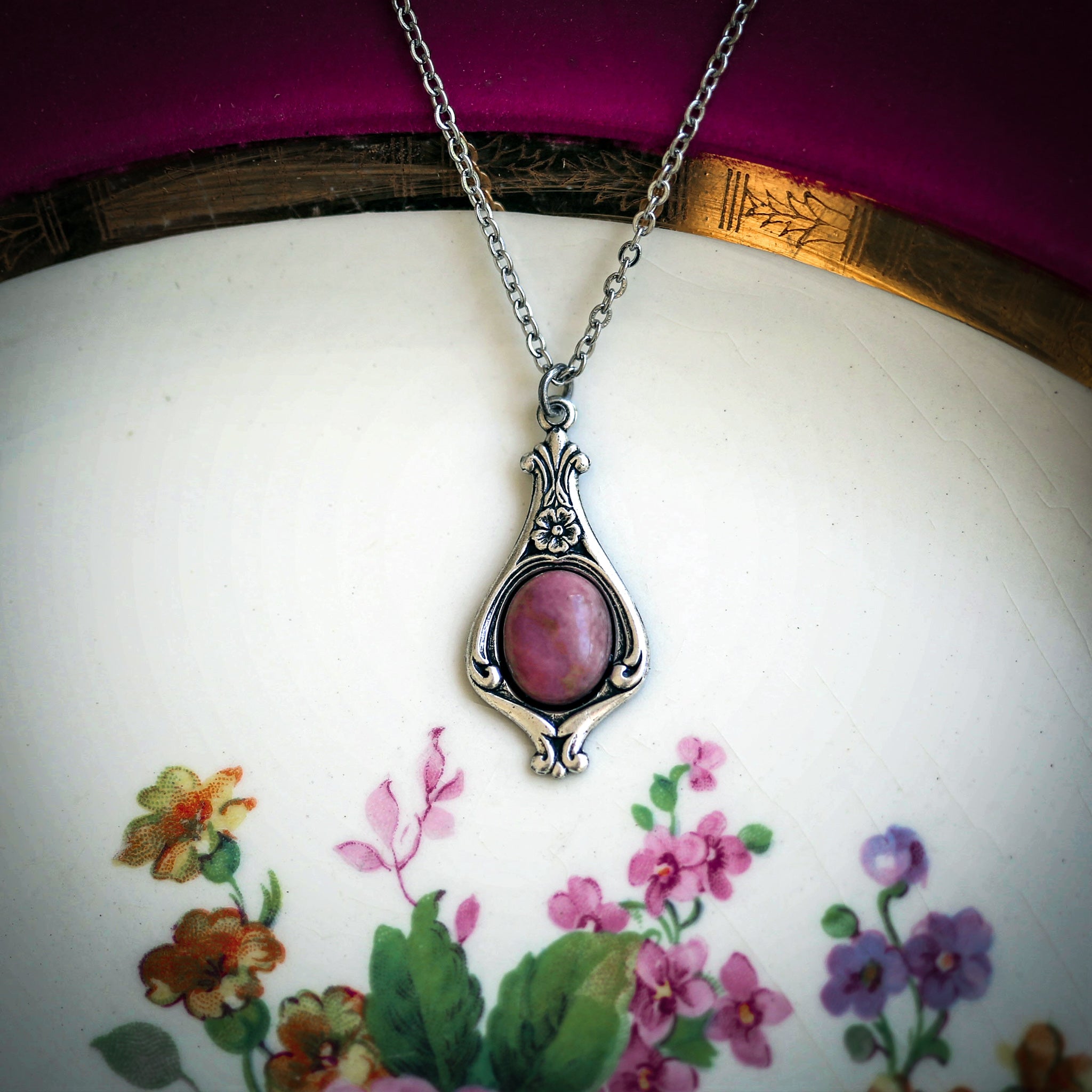 Antiqued silver vintage-inspired small pastel goth aesthetic necklace with a dainty pink rose rhodonite stone on a mini floral drop setting.