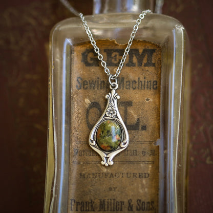 Antiqued silver vintage inspired small military camo aesthetic necklace with a dainty green unakite stone on a mini floral drop setting.