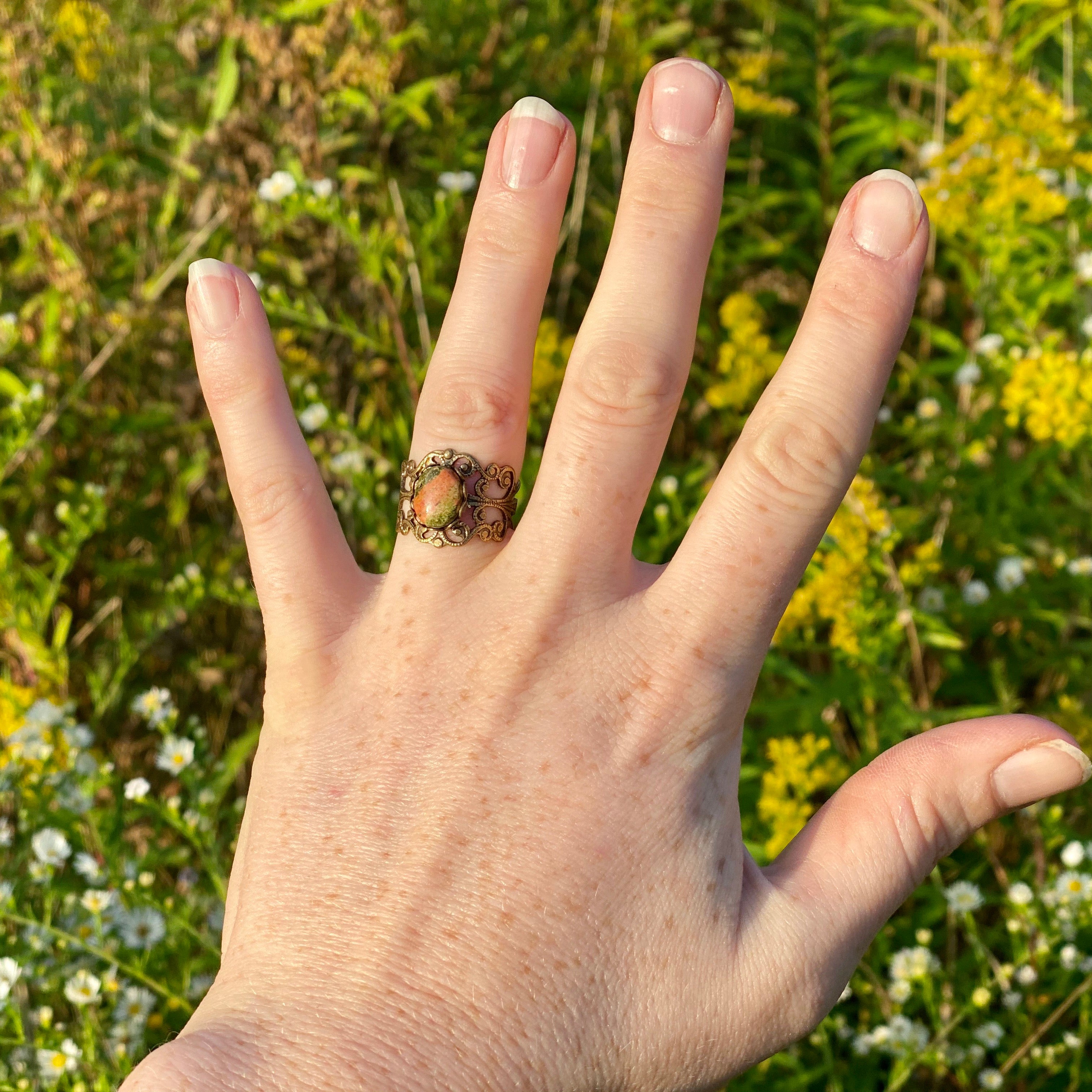 Antiqued brass modern vintage inspired adjustable filigree cocktail ring with orange and green unakite semi-precious stone oval mineral in a bookstore girl aesthetic