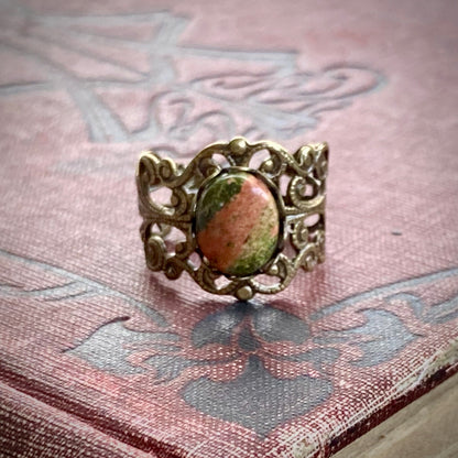 Antiqued brass modern vintage inspired adjustable filigree cocktail ring with orange and green unakite semi-precious stone oval mineral in a cottagecore aesthetic