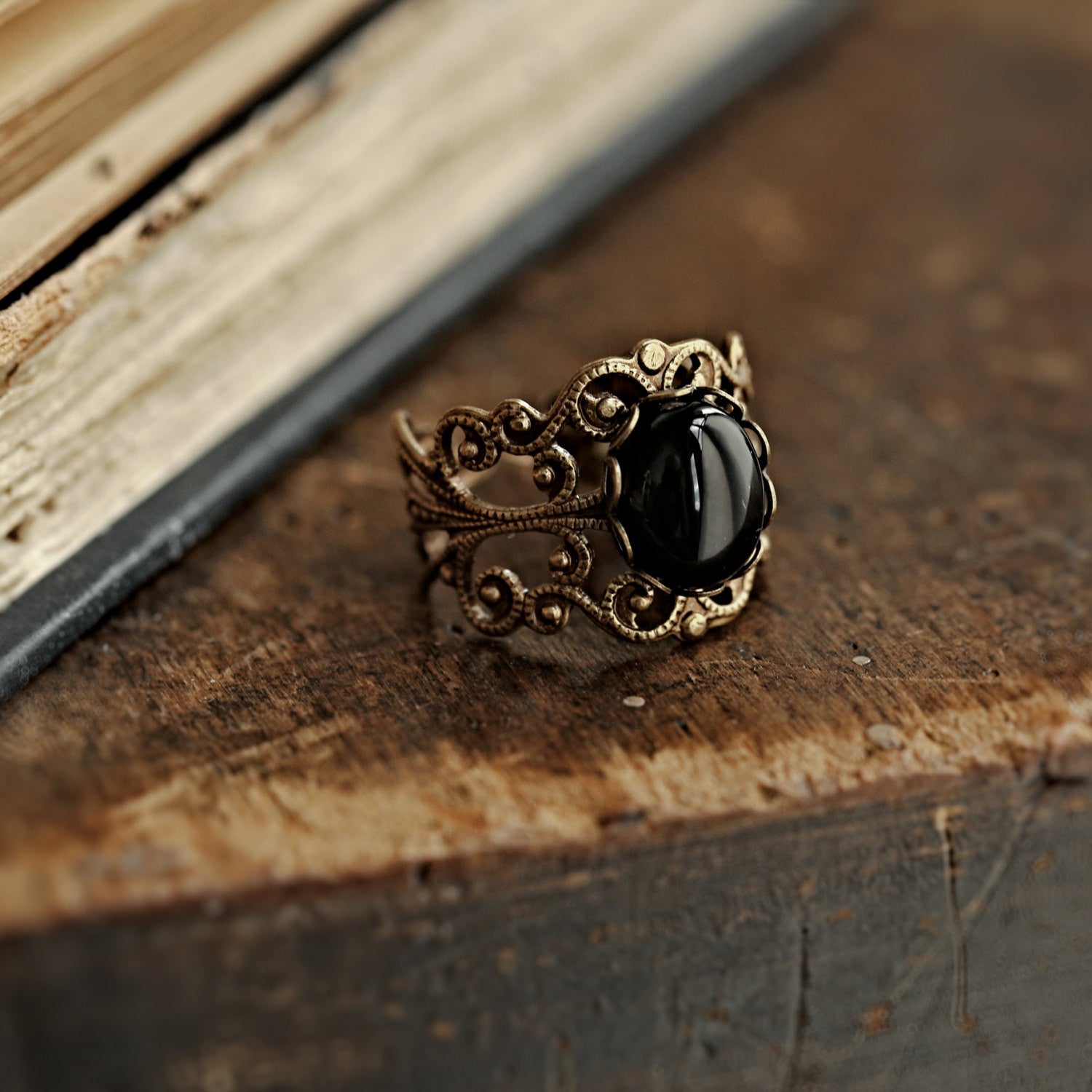 Antiqued silver modern vintage inspired adjustable filigree statement ring with a black oval onyx semi-precious stone mineral cabochon in witchy academia style