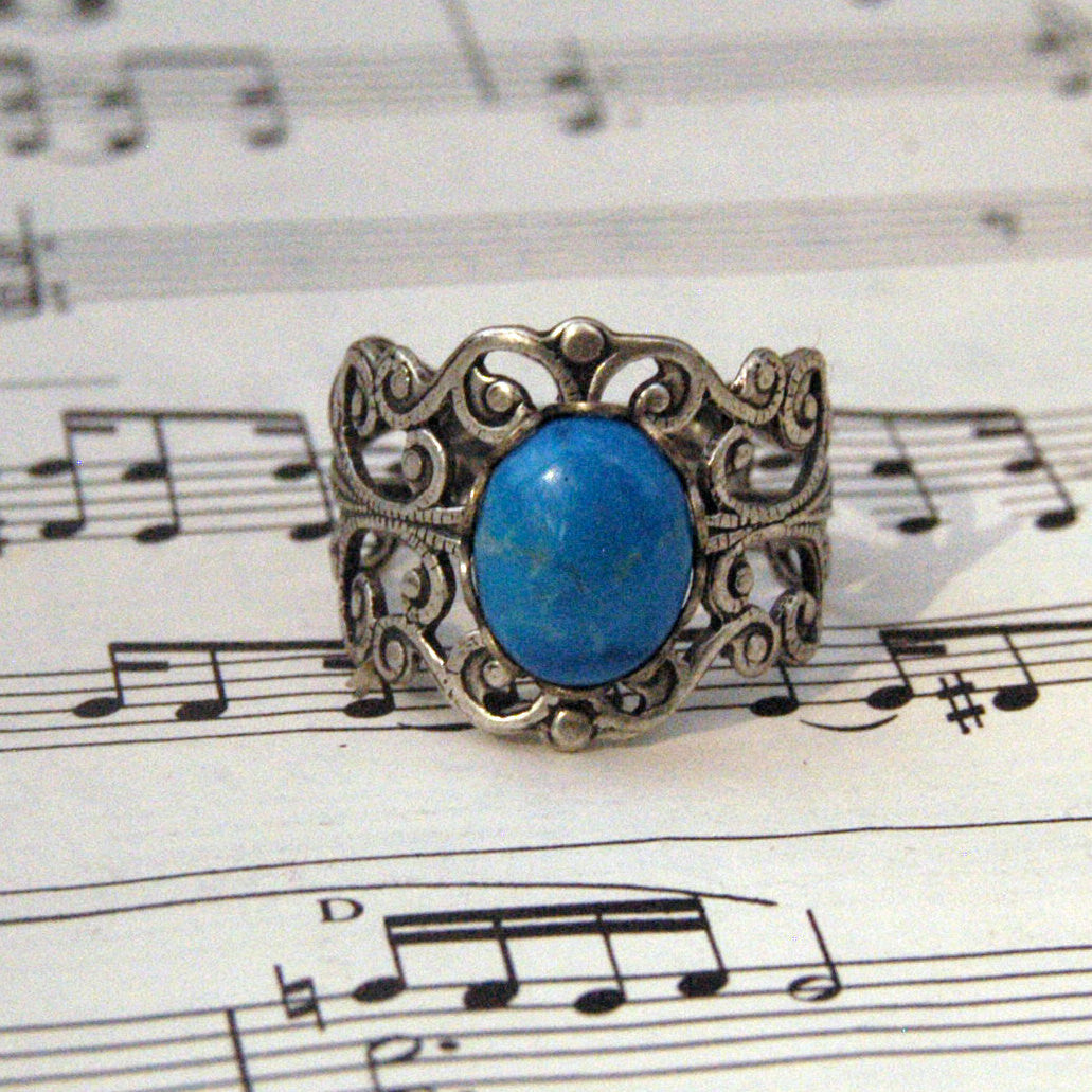 antiqued brass modern vintage inspired adjustable filigree ring with a turquoise blue howlite oval semi-precious mineral stone in the coastal grandmother fashion aesthetic.