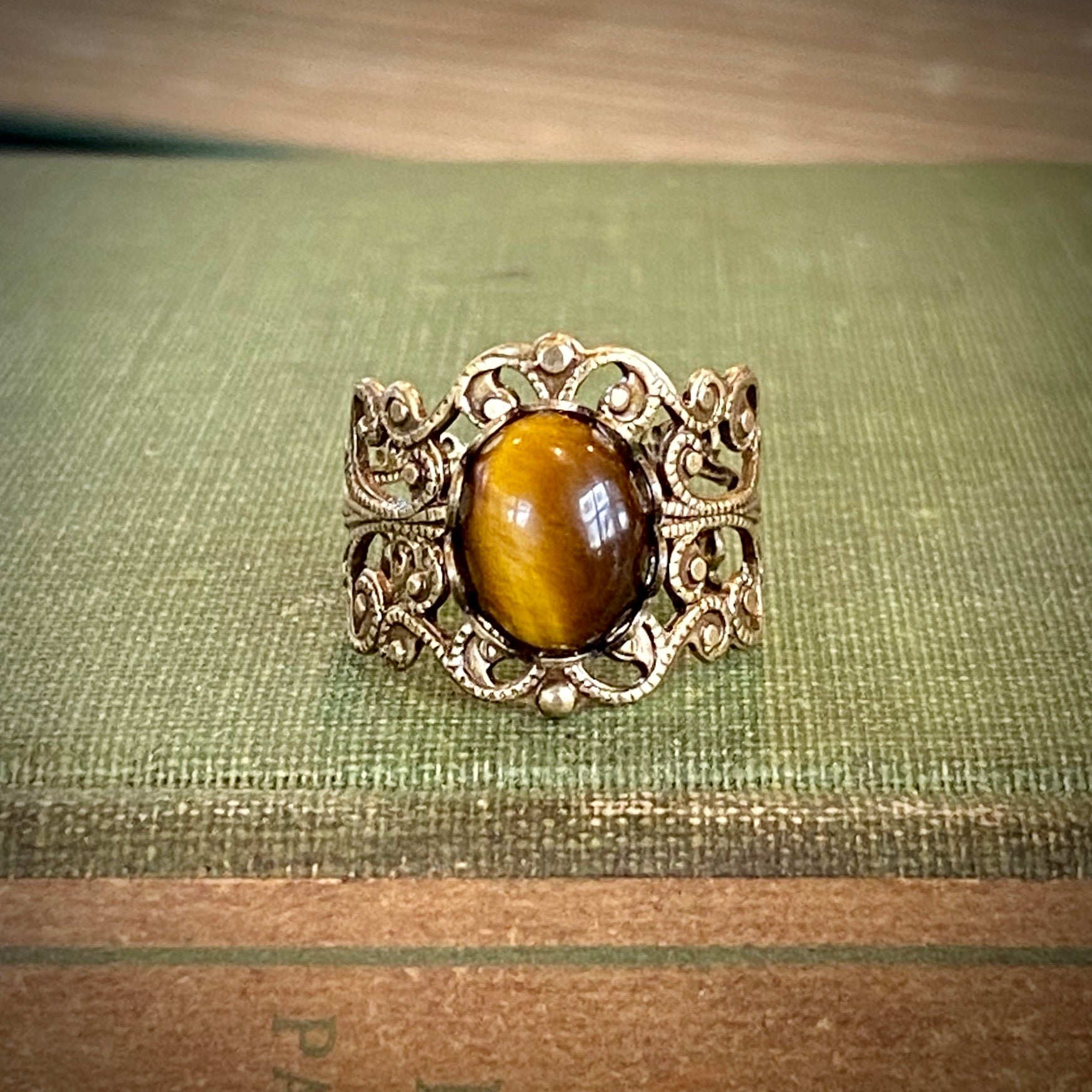 antiqued brass mod vintage inspired adjustabel filigree ring with brown oval tiger eye semi-precious stone mineral perfect for a crowcore outfit.