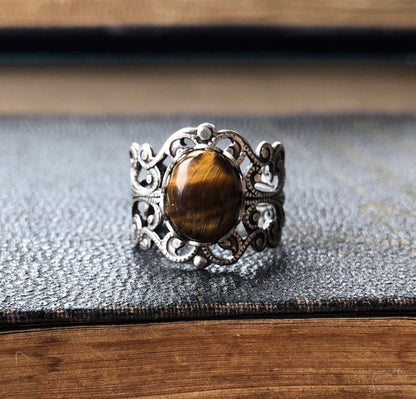 antiqued silver modern vintage inspired adjustable filigree ring with brown oval tiger eye semi-precious stone mineral perfect for an autumn academia outfit.