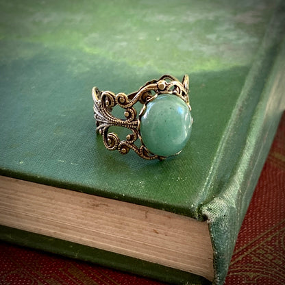 Antiqued brass adjustable vintage-inspired filigree ring with a green aventurine semi-precious stone mineral in the mosscore aesthetic