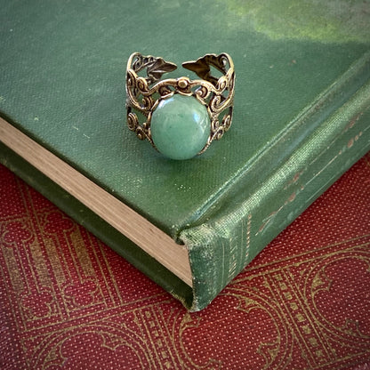 Antiqued brass adjustable vintage-inspired filigree ring with a green aventurine semi-precious stone mineral in the woodlandcore aesthetic